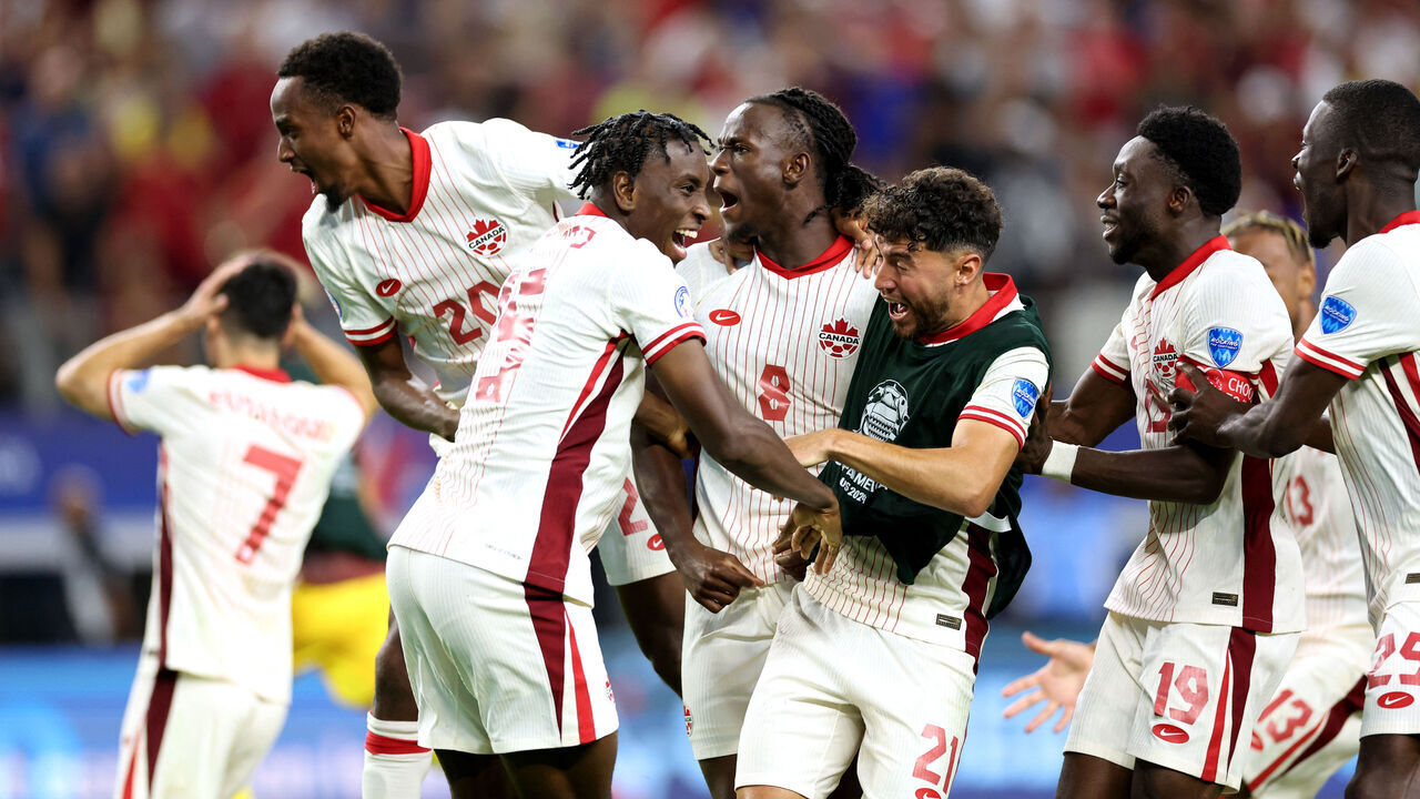 Canada's players celebrate their victory after a penalty shoot-out during the Conmebol 2024 Copa America tournament quarter-final football match between Venezuela and Canada at AT&T Stadium in Arlington, Texas, on July 5, 2024.