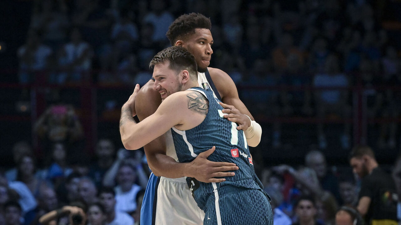 Greece's Giannis Antetokounmpo (L) hugs Slovenia's Luka Doncic prior to the 2024 FIBA Olympic Qualifying Tournament semi-final basketball match between Dominican Republic and Greece at the Peace and Friendship Stadium in Athens, on July 6, 2024.