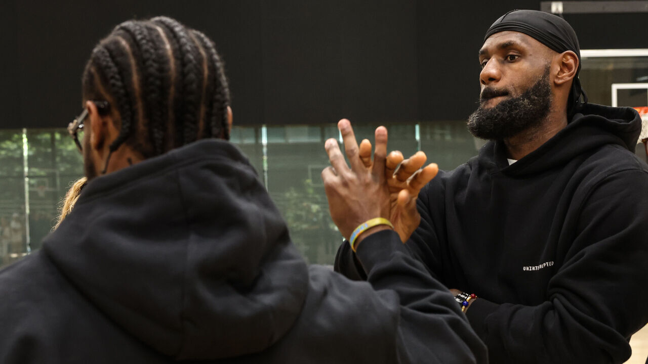 El Segundo, CA, Tuesday, July 2, 2024 - Lakers star LeBron James shakes hands with his son, Bronny after a press conference at the UCLA Health Training Center. (Robert Gauthier/Los Angeles Times via Getty Images)