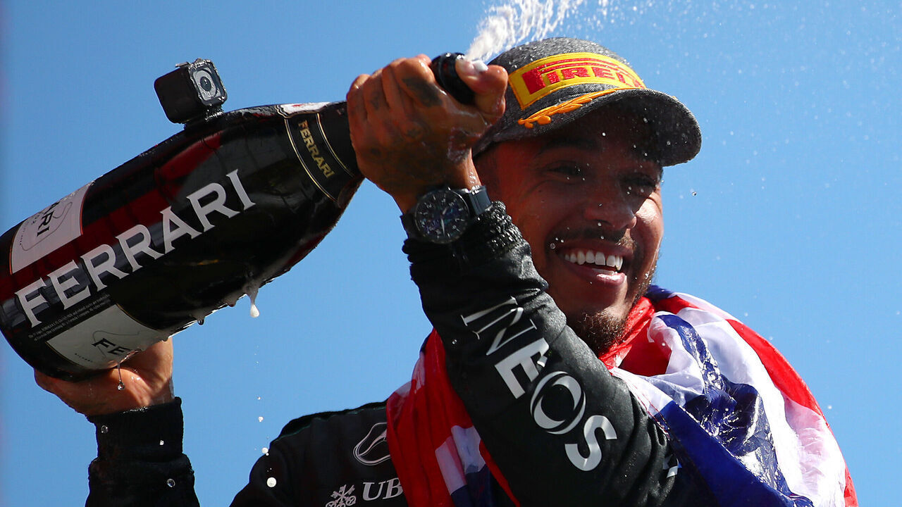 NORTHAMPTON, ENGLAND - JULY 07: Race winner Lewis Hamilton of Great Britain and Mercedes celebrates on the podium during the F1 Grand Prix of Great Britain at Silverstone Circuit on July 07, 2024 in Northampton, England.