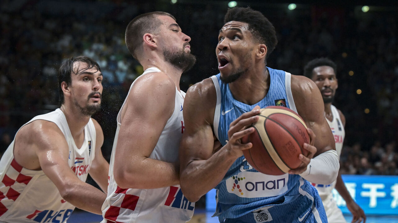 Greece's Giannis Antetokounmpo (R) is marked by Croatia's Ivica Zubak (C) during the 2024 FIBA Olympic Qualifying Tournament semi-final basketball match between Greece and Croatia at the Peace and Friendship Stadium in Athens, on July 7, 2024.