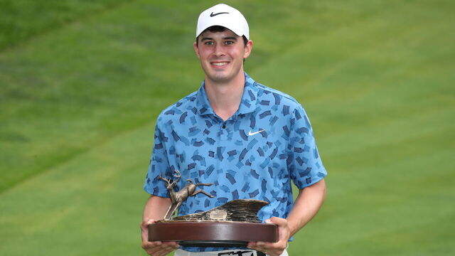 SILVIS, IL - JULiY 07: PGA golfer Davis Thompson poses with the trophy after winning the John Deere Classic on July 7,2024, at the TPC Deere Run in Silvis, Illinois.