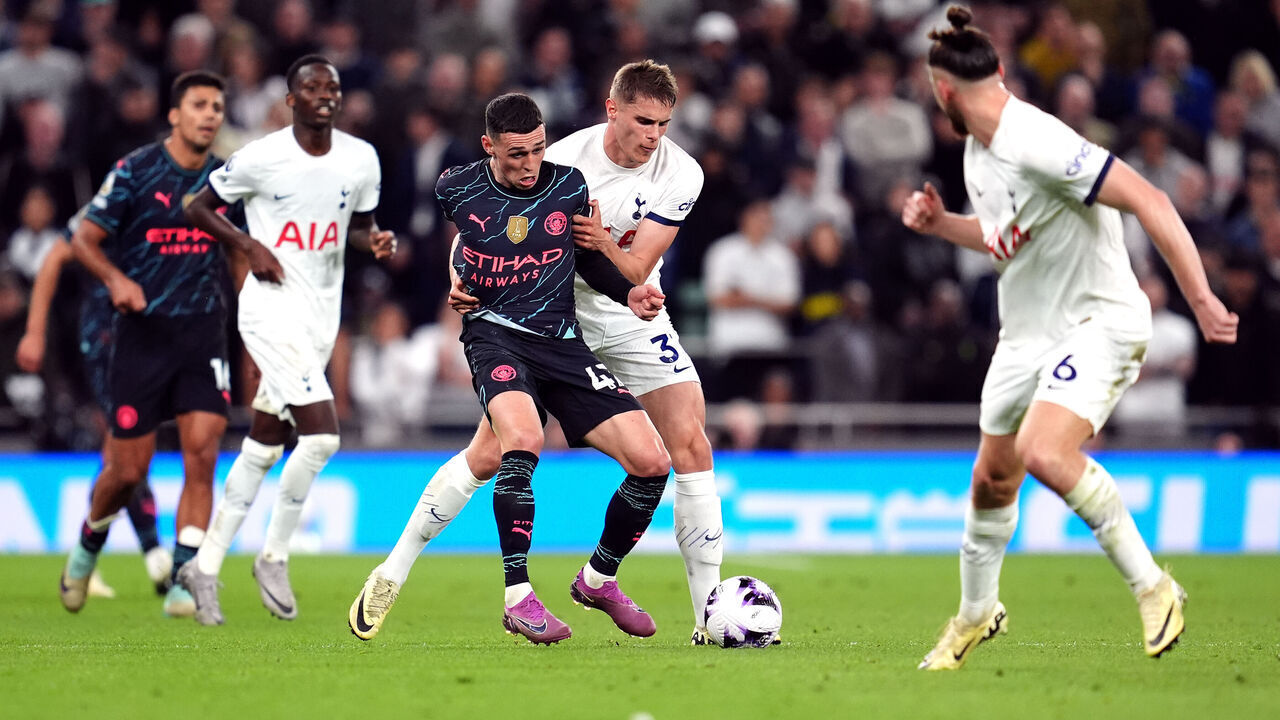 Tottenham Hotspur's Micky van de Ven and Manchester City's Phil Foden battle for the ball during the Premier League match at the Tottenham Hotspur Stadium, London. Picture date: Tuesday May 14, 2024.