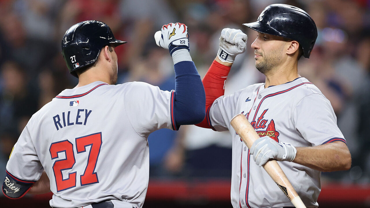 PHOENIX, ARIZONA - JULY 08: Matt Olson #28 of the Atlanta Braves high fives Austin Riley #27 after Riley hit a solo home run against the Arizona Diamondbacks during the first inning of the MLB game at Chase Field on July 08, 2024 in Phoenix, Arizona.