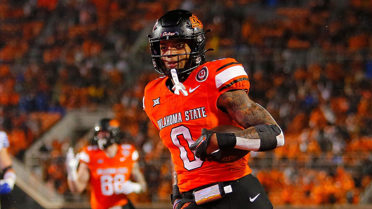 STILLWATER, OK - NOVEMBER 25: Running back Ollie Gordon II #0 of the Oklahoma State Cowboys sticks out his tongue after scoring a go-ahead touchdown against the BYU Cougars late in the fourth quarter at Boone Pickens Stadium on November 25, 2023 in Stillwater, Oklahoma. Oklahoma State won 40-34 in double overtime.