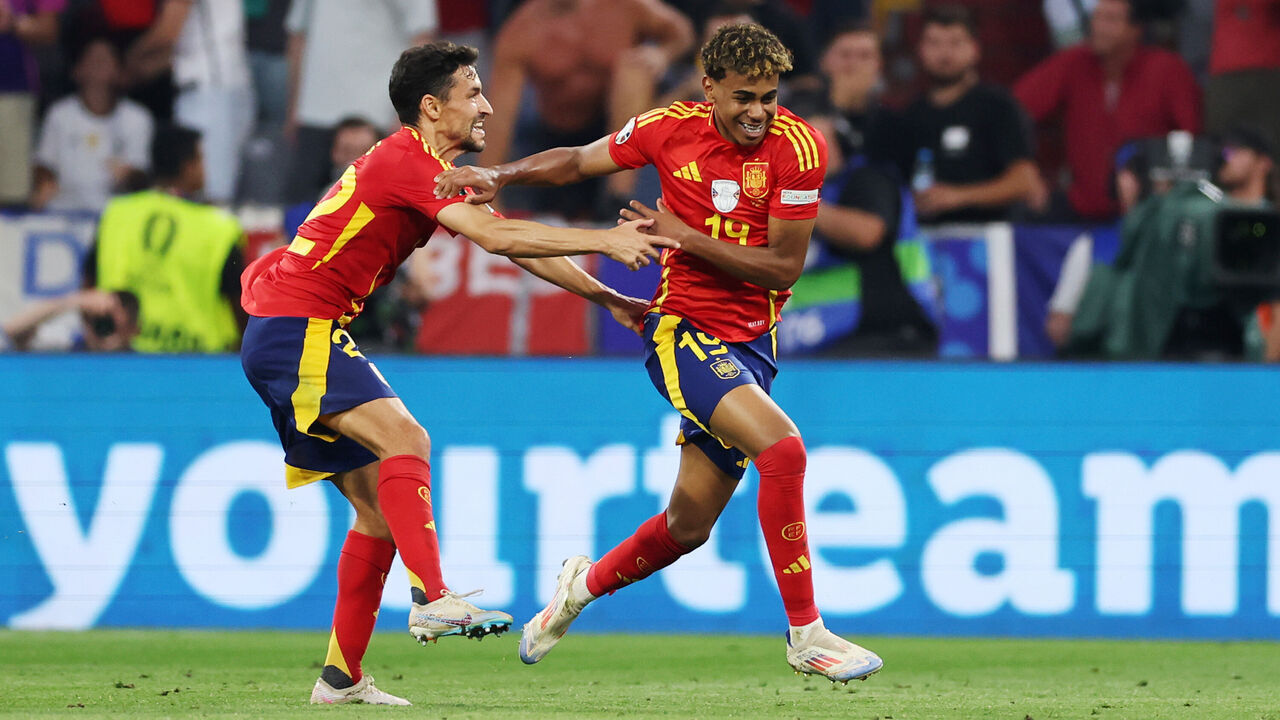 MUNICH, GERMANY - JULY 09: Lamine Yamal of Spain celebrates scoring his team's first goal with teammate Jesus Navas during the UEFA EURO 2024 Semi-Final match between Spain and France at Munich Football Arena on July 09, 2024 in Munich, Germany.