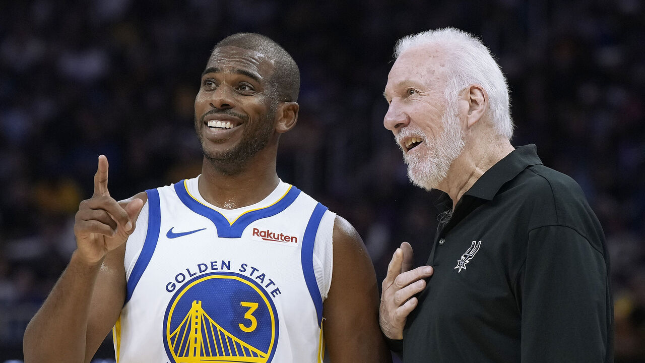 SAN FRANCISCO, CALIFORNIA - OCTOBER 20: Chris Paul #3 of the Golden State Warriors jokes with head coach Gregg Popovich of the San Antonio Spurs during a break in the action of an NBA basketball game at Chase Center on October 20, 2023 in San Francisco, California.