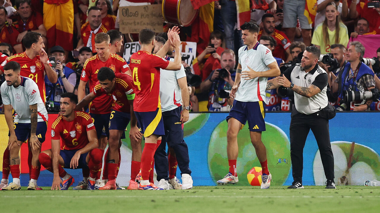 MUNICH, GERMANY - JULY 09: Alvaro Morata of Spain reacts after a Member of Security collided with him whilst attempting to remove a Pitch Invader as players of Spain celebrate in front of their fans after the UEFA EURO 2024 Semi-Final match between Spain and France at Munich Football Arena on July 09, 2024 in Munich, Germany.