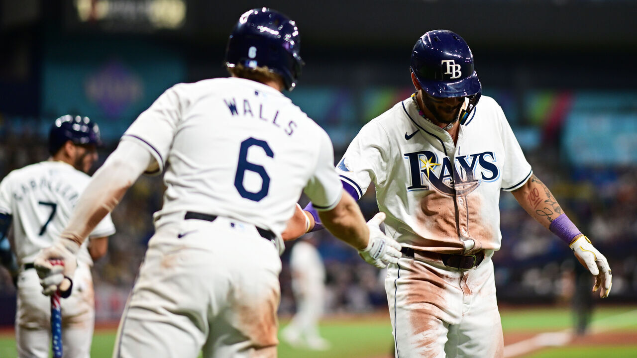 ST PETERSBURG, FLORIDA - JULY 09: Jose Siri #22 of the Tampa Bay Rays celebrates with Taylor Walls #6 after scoring in the eighth inning against the New York Yankees at Tropicana Field on July 09, 2024 in St Petersburg, Florida.