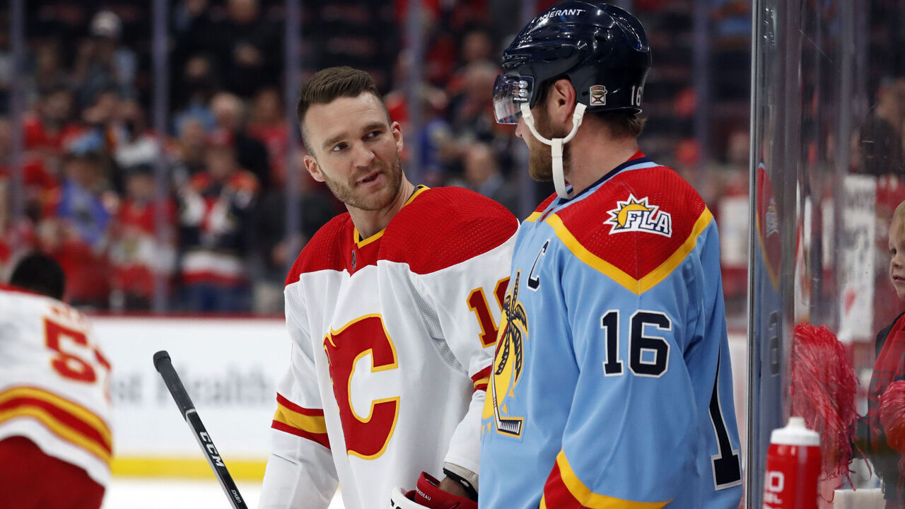 SUNRISE, FLORIDA - NOVEMBER 19: Jonathan Huberdeau #10 of the Calgary flames talks with former teammate Aleksander Barkov #16 of the Florida Panthers at the FLA Live Arena on November 19, 2022 in Sunrise, Florida.