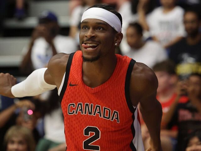 TORONTO, ON- JULY 6 - Shai Gilgeous-Alexander uses a little body English to help a shot into the basket as the Superfan Nav Bhatia hosts a send off for the Men's, Women's, and wheelchair basketball teams representing Canada at the Paris 2024 Summer Olympic Games at Goldring Centre for High Performance Sport in Toronto. July 6, 2024. Steve Russell/Toronto Star (Steve Russell/Toronto Star via Getty Images)
