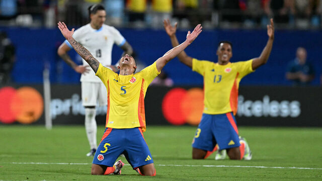 Colombia's midfielder #05 Kevin Castano and Colombia's defender #13 Yerry Mina celebrate their team's victory in the Conmebol 2024 Copa America tournament semi-final football match between Uruguay and Colombia at Bank of America Stadium, in Charlotte, North Caroline on July 10, 2024.
