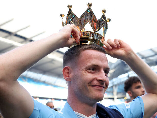 MANCHESTER, ENGLAND - MAY 19: Sergio Gomez of Manchester City poses with the Premier League trophy crown after the Premier League match between Manchester City and West Ham United at Etihad Stadium on May 19, 2024 in Manchester, England.