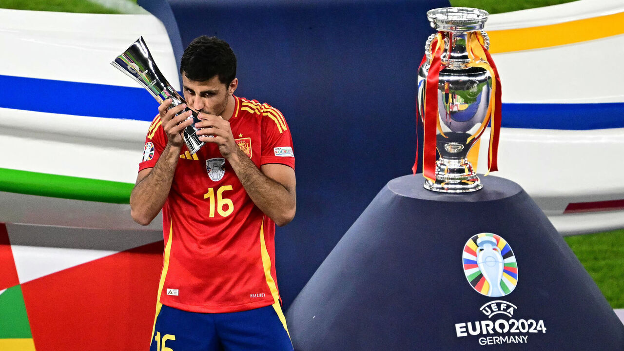 Spain's midfielder #16 Rodri celebrates winning the player of the tournament award after the UEFA Euro 2024 final football match between Spain and England at the Olympiastadion in Berlin on July 14, 2024.