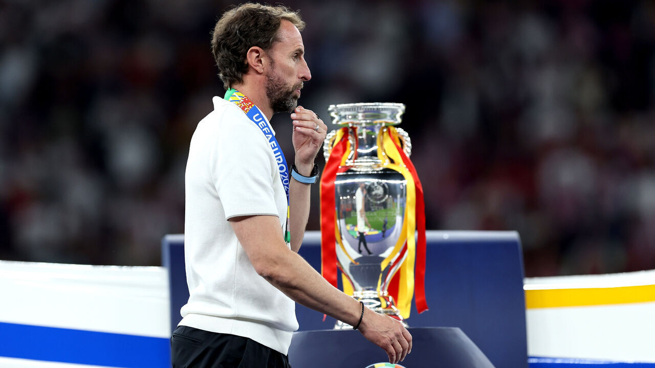 BERLIN, GERMANY - JULY 14: Gareth Southgate, Head Coach of England, looks dejected as he walks past the UEFA Euro 2024 Henri Delaunay Trophy after collecting his Runners Up Medal after the UEFA EURO 2024 final match between Spain and England at Olympiastadion on July 14, 2024 in Berlin, Germany.