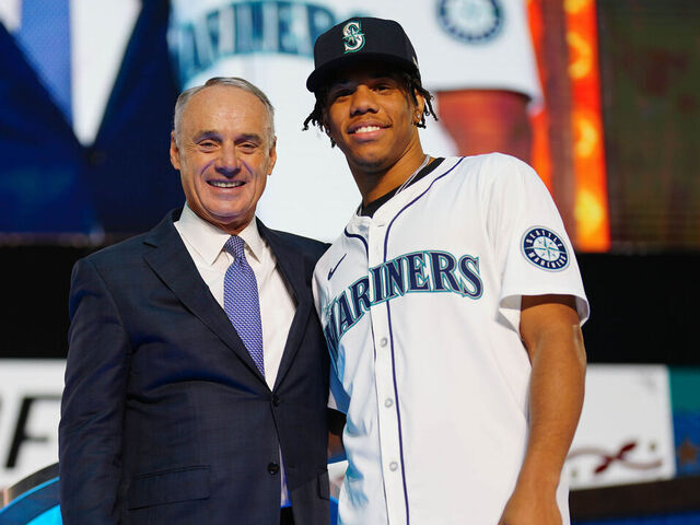 FORT WORTH, TX - JULY 14: Jurrangelo Cijntje poses for a photo with Major League Baseball commissioner Robert D. Manfred Jr. after being drafted by the Seattle Mariners with the 15th pick of the first round during the 2024 MLB Draft presented by Nike at Cowtown Coliseum on Sunday, July 14, 2024 in Fort Worth, Texas.
