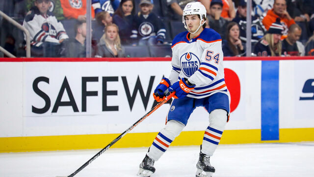 WINNIPEG, CANADA - OCTOBER 1: Xavier Bourgault #54 of the Edmonton Oilers keeps an eye on the play during third period pre-season action against the Winnipeg Jets at the Canada Life Centre on October 1, 2022 in Winnipeg, Manitoba, Canada. The Oilers defeated the Jets 3-2 in the shootout.