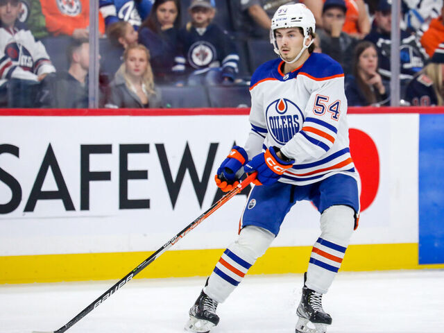 WINNIPEG, CANADA - OCTOBER 1: Xavier Bourgault #54 of the Edmonton Oilers keeps an eye on the play during third period pre-season action against the Winnipeg Jets at the Canada Life Centre on October 1, 2022 in Winnipeg, Manitoba, Canada. The Oilers defeated the Jets 3-2 in the shootout.