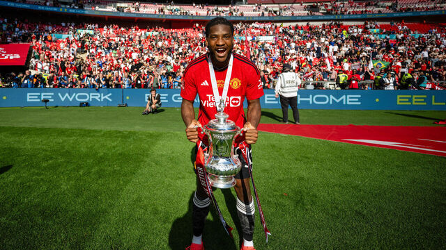 LONDON, ENGLAND - MAY 25: Willy Kambwala of Manchester United celebrates with the Emirates FA Cup trophy after winning the Emirates FA Cup Final match between Manchester City and Manchester United at Wembley Stadium on May 25, 2024 in London, England.