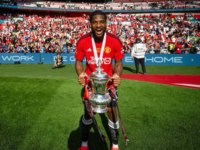 LONDON, ENGLAND - MAY 25: Willy Kambwala of Manchester United celebrates with the Emirates FA Cup trophy after winning the Emirates FA Cup Final match between Manchester City and Manchester United at Wembley Stadium on May 25, 2024 in London, England.