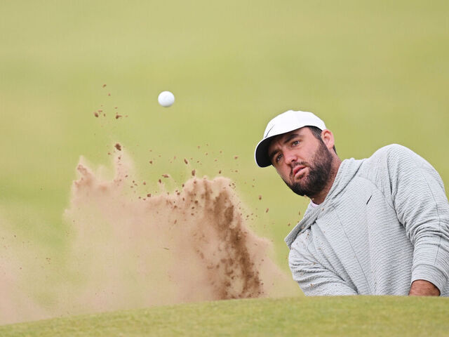 TROON, SCOTLAND - JULY 14: Scottie Scheffler of the United States plays a shot from a bunker during a practice round prior to The 152nd Open championship at Royal Troon on July 14, 2024 in Troon, Scotland.