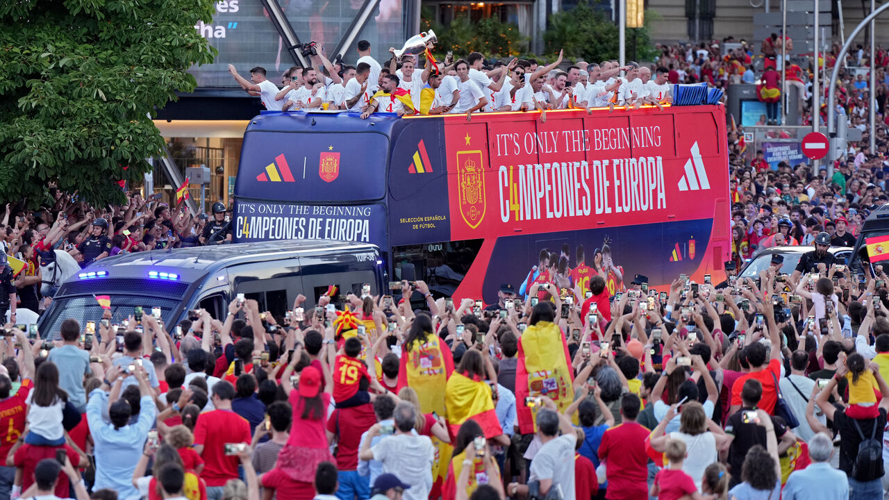 Spanish national football team players parade on board of a bus as Spain fans gather to celebrate, on July 15, 2024, after Spain won the UEFA Euro 2024 final football match between Spain and England.