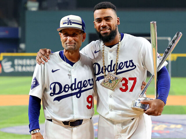 ARLINGTON, TEXAS - JULY 15: Teoscar Hernández #37 of the Los Angeles Dodgers poses with the trophy and Dino Ebel #91 after winning the T-Mobile Home Run Derby at Globe Life Field on July 15, 2024 in Arlington, Texas.