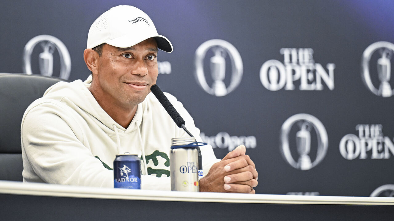 TROON, SCOTLAND - JULY 16: Tiger Woods smiles at a press conference during practice for The 152nd Open Championship at Royal Troon on July 16, 2024 in Troon, Scotland.