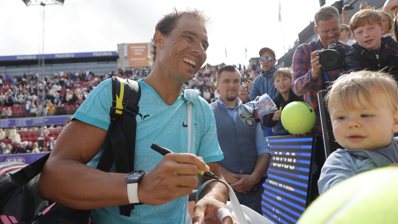 Spain's Rafael Nadal signs autographs after winning the men's doubles tennis match with Norway's Casper Ruud during the Nordea Open ATP tennis tournament in Bastad, Sweden, on July 15, 2024. Rafael Nadal teamed up with Casper Ruud in the doubles at the ATP Bastad Open, Sweden, where he is also playing singles as part of his preparations for the Paris Olympics.