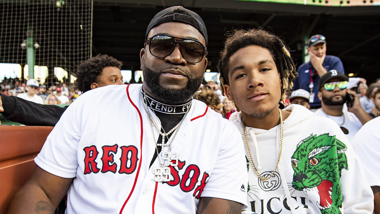 BOSTON, MA - JUNE 20: Former designated hitter David Ortiz of the Boston Red Sox poses for a photograph with his son DAngelo Ortiz after presenting a Boston Red Sox Hall of Fame plaque to former left fielder Manny Ramirez during a pre-game ceremony before a game against the Detroit Tigers on June 20, 2022 at Fenway Park in Boston, Massachusetts.