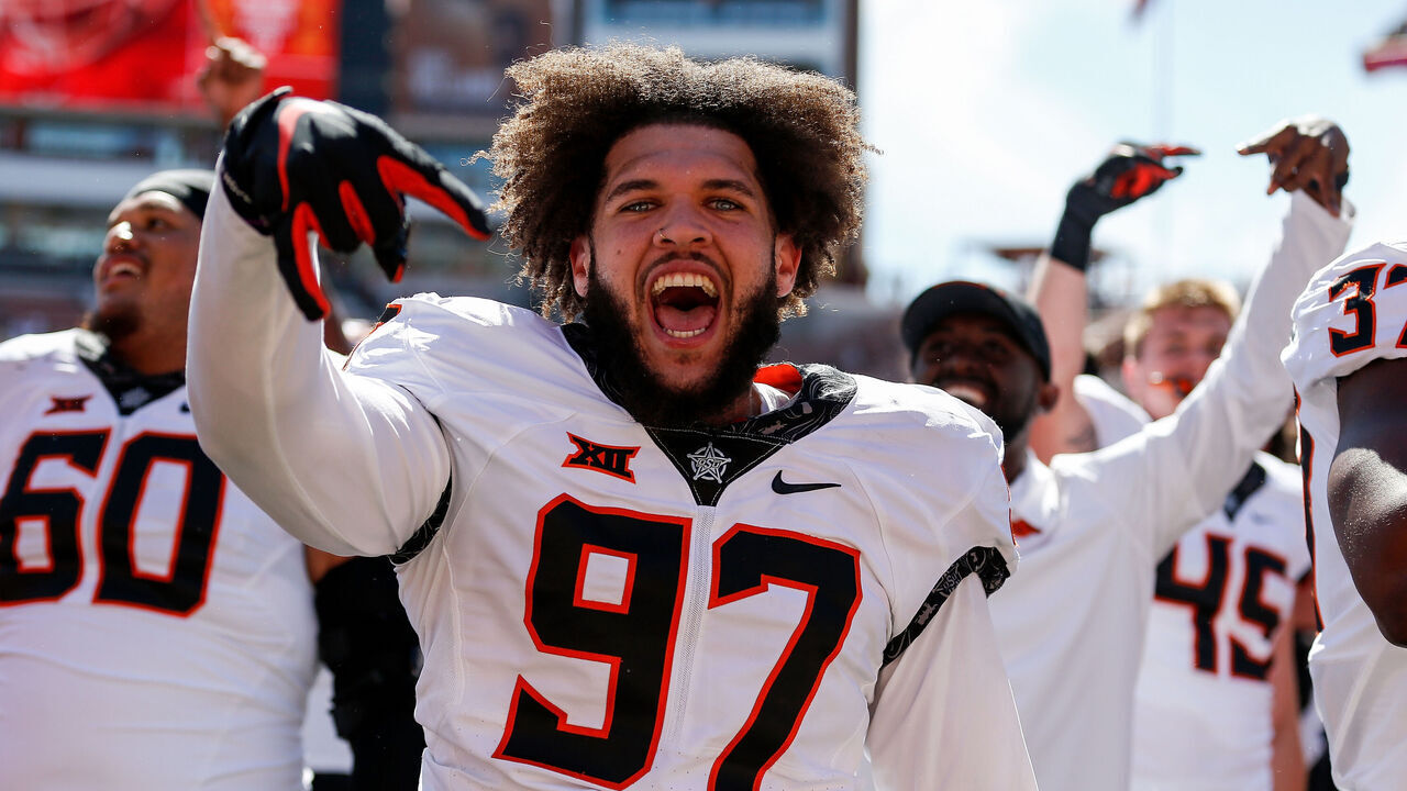 AUSTIN, TEXAS - OCTOBER 16: Ian Marshall #97 of the Oklahoma State Cowboys celebrates with the horns down sign after defeating the Texas Longhorns at Darrell K Royal-Texas Memorial Stadium on October 16, 2021 in Austin, Texas.