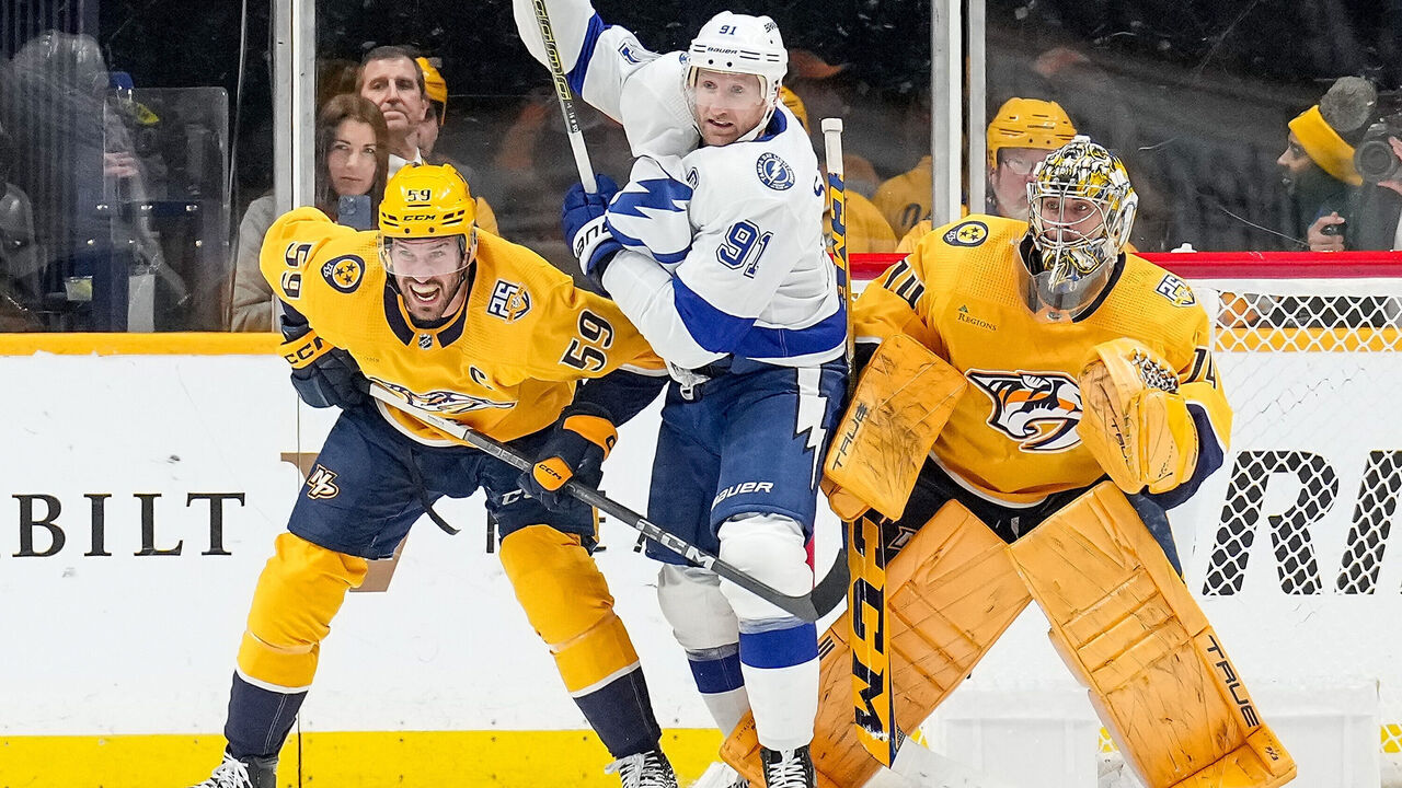NASHVILLE, TENNESSEE - DECEMBER 7: Steven Stamkos #91 of the Tampa Bay Lightning battles in front of the net against Roman Josi #59 and Juuse Saros #74 of the Nashville Predators during an NHL game at Bridgestone Arena on December 7, 2023 in Nashville, Tennessee.