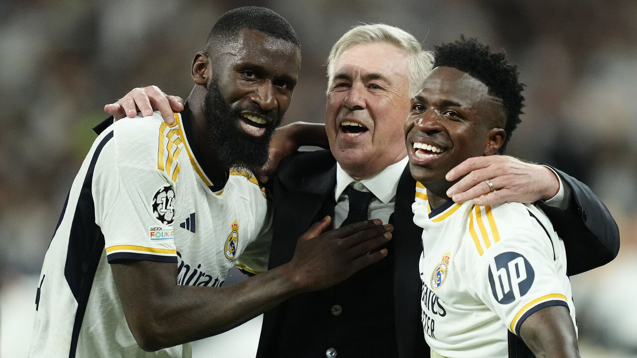 (L-R) Antonio Rudiger centre-back of Real Madrid and Germany , Carlo Ancelotti head coach of Real Madrid and Vinicius Junior left winger of Real Madrid and Brazil celebrates victory after the UEFA Champions League semi-final second leg match between Real Madrid and FC Bayern München at Estadio Santiago Bernabeu on May 8, 2024 in Madrid, Spain.
