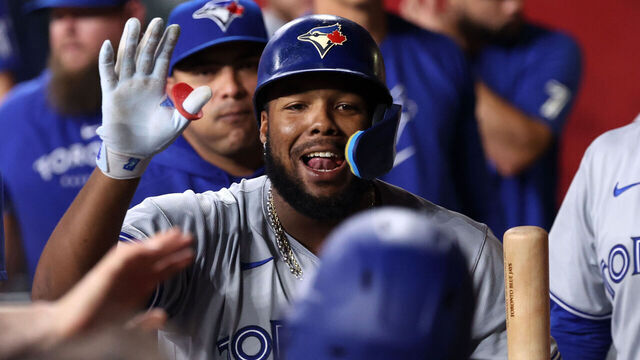 PHOENIX, ARIZONA - JULY 12: Vladimir Guerrero Jr. #27 of the Toronto Blue Jays celebrates with teammates after hitting a sacrifice fly during the eighth inning against the Arizona Diamondbacks at Chase Field on July 12, 2024 in Phoenix, Arizona.