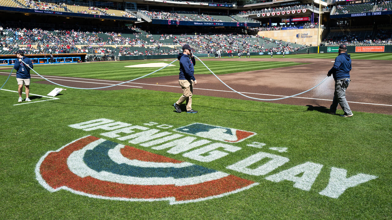 MINNEAPOLIS, MINNESOTA - APRIL 6: A view of an Opening Day logo as grounds crew hoses down the infield before the game Cleveland Guardians and Minnesota Twins at Target Field on April 6, 2024 in Minneapolis, Minnesota.