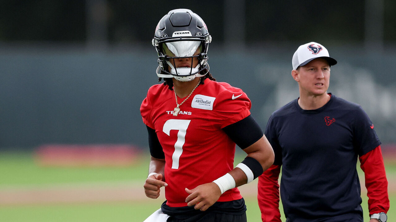 HOUSTON, TEXAS - JUNE 05: C.J. Stroud #7 of the Houston Texans and offensive coordinator Bobby Slowik stand on the field during mandatory minicamp at Houston Methodist Training Center on June 05, 2024 in Houston, Texas.