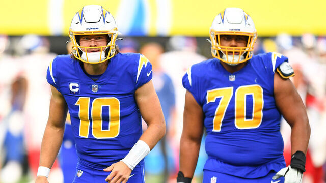 INGLEWOOD, CA - DECEMBER 12: Los Angeles Chargers Quarterback Justin Herbert (10) celebrates with Los Angeles Chargers Offensive Tackle Rashawn Slater (70) during the NFL game between the New York Giants and the Los Angeles Chargers on December 12, 2021, at SoFi Stadium in Inglewood, CA.