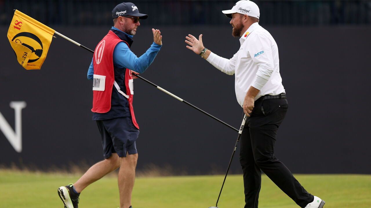 TROON, SCOTLAND - JULY 19: Shane Lowry of Ireland shakes hands with his caddie Darren Reynolds after finishing his round on the 18th green during day two of The 152nd Open championship at Royal Troon on July 19, 2024 in Troon, Scotland.