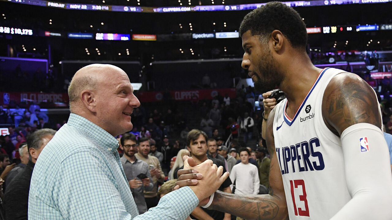 LOS ANGELES, CA - NOVEMBER 20: Paul George #13 of the Los Angeles Clippers is congratulated by owner owner Steve Ballmer after an overtime win over Boston Celtics, 107-104, at Staples Center on November 20, 2019 in Los Angeles, California. NOTE TO USER: User expressly acknowledges and agrees that, by downloading and/or using this Photograph, user is consenting to the terms and conditions of the Getty Images License Agreement.