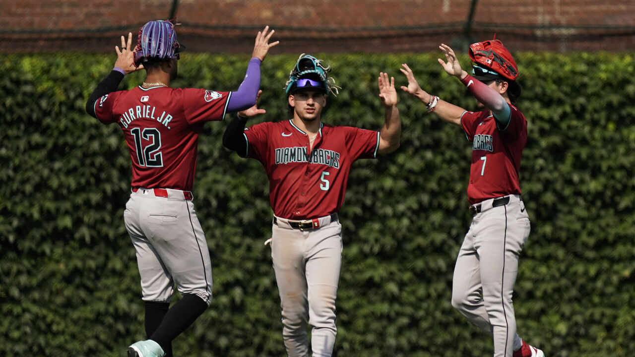 CHICAGO, ILLINOIS - JULY 19: (L-R) Lourdes Gurriel Jr. #12 Alek Thomas #5 and Corbin Carroll #7 of the Arizona Diamondbacks celebrate after their team win over the Chicago Cubs at Wrigley Field on July 19, 2024 in Chicago, Illinois. The Diamondbacks defeated the Cubs 5-2.