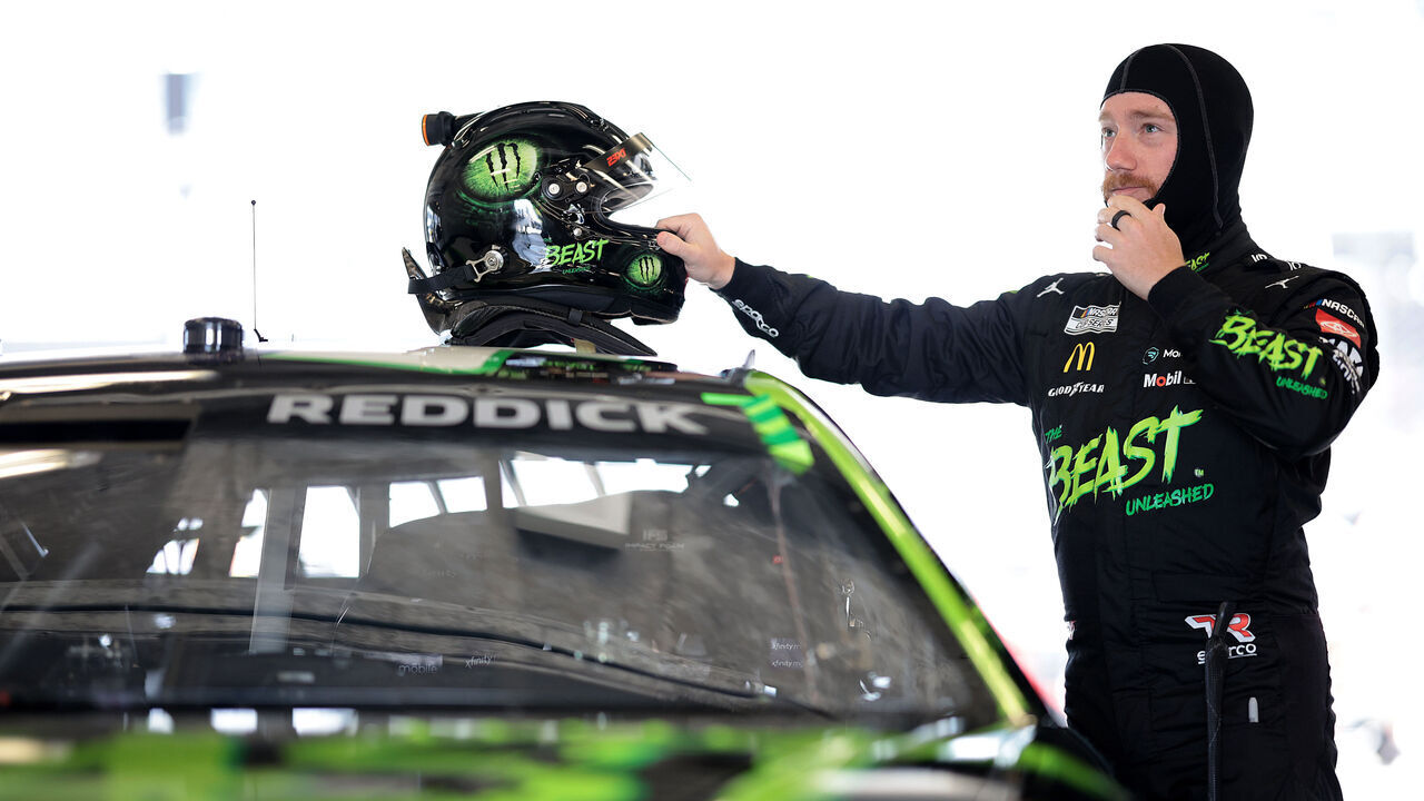 INDIANAPOLIS, INDIANA - JULY 19: Tyler Reddick, driver of the #45 The Beast Unleashed Toyota, prepares in the garage area to practice for the NASCAR Cup Series Brickyard 400 at Indianapolis Motor Speedway on July 19, 2024 in Indianapolis, Indiana.