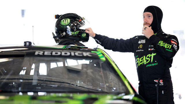 INDIANAPOLIS, INDIANA - JULY 19: Tyler Reddick, driver of the #45 The Beast Unleashed Toyota, prepares in the garage area to practice for the NASCAR Cup Series Brickyard 400 at Indianapolis Motor Speedway on July 19, 2024 in Indianapolis, Indiana.