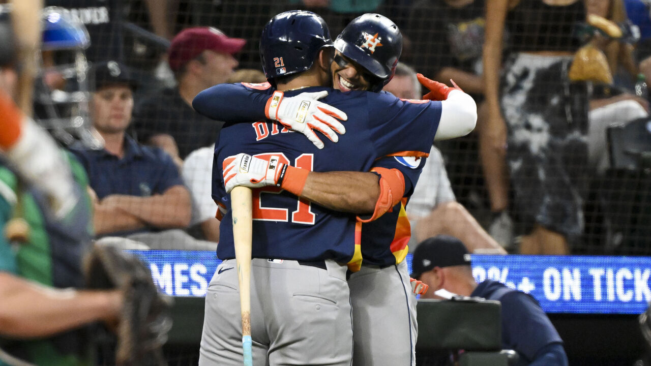 SEATTLE, WASHINGTON - JULY 20: Yainer Diaz #21 of the Houston Astros hugs Jeremy Pena #3 after hitting a solo home run during the eighth inning against the Seattle Mariners at T-Mobile Park on July 20, 2024 in Seattle, Washington.