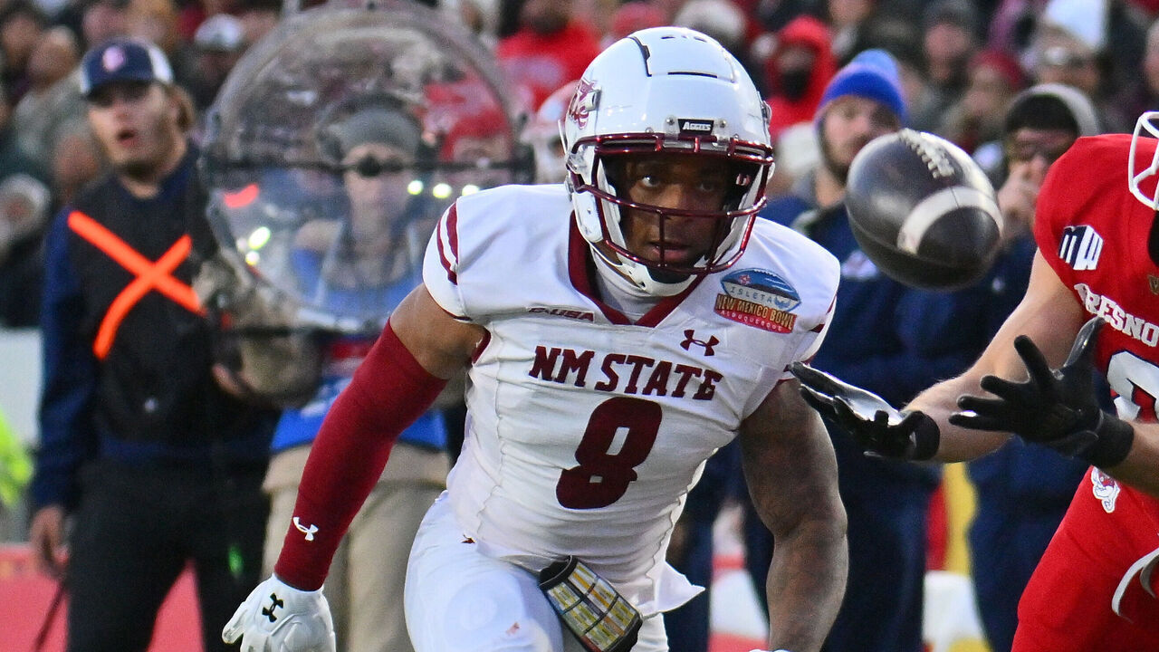 ALBUQUERQUE, NEW MEXICO - DECEMBER 16: Wide receiver Mac Dalena #0 of the Fresno State Bulldogs tries to catch a pass against cornerback Andre Seldon #8 of the New Mexico State Aggies during the first half of the Isleta New Mexico Bowl at University Stadium on December 16, 2023 in Albuquerque, New Mexico.