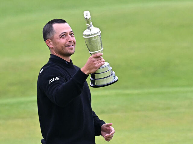 US golfer Xander Schauffele poses with the Claret Jug, the trophy for the Champion golfer of the year after winning the 152nd British Open Golf Championship at Royal Troon on the south west coast of Scotland on July 21, 2024.
