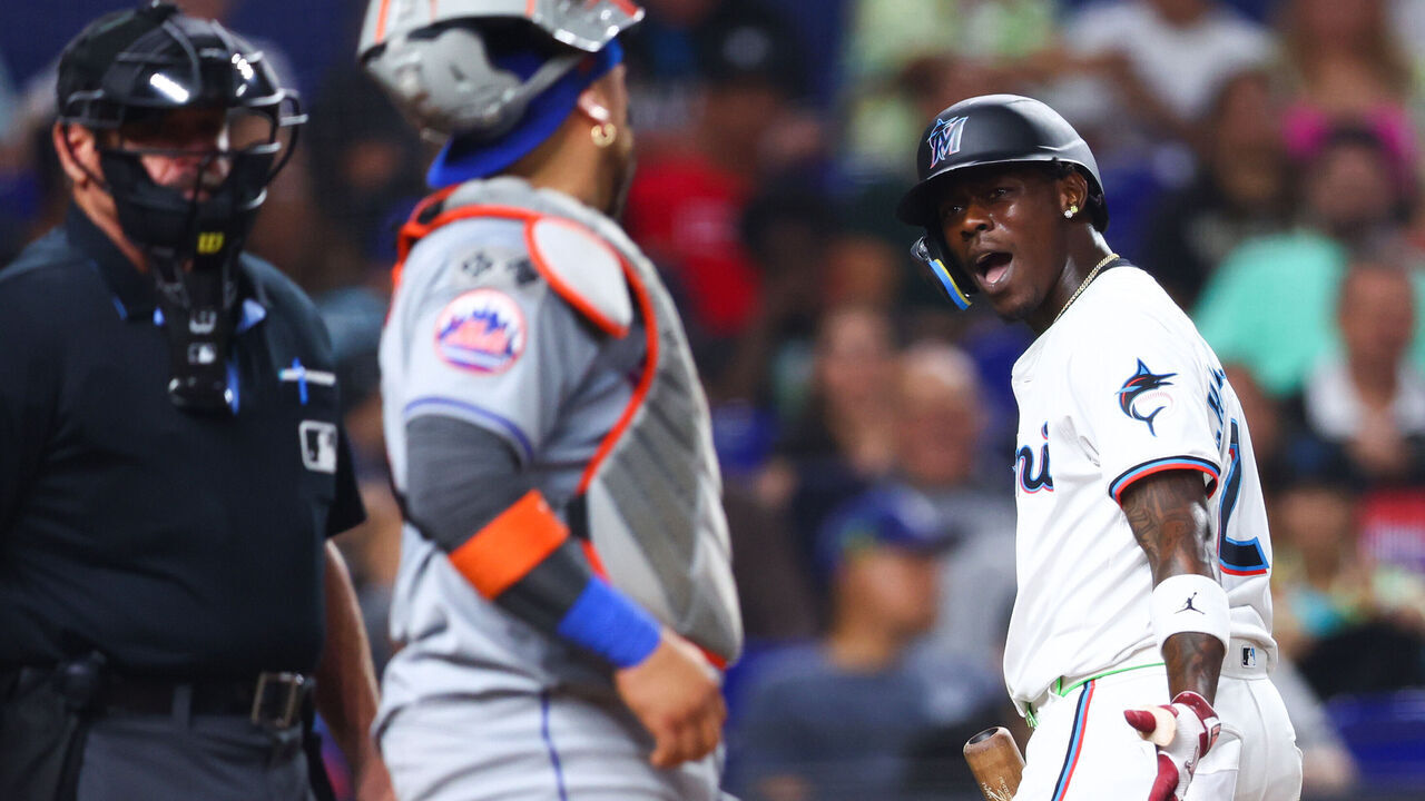 MIAMI, FLORIDA - JULY 22: Jazz Chisholm Jr. #2 of the Miami Marlins (R) reacts after striking out against the New York Mets during the seventh inning of the game at loanDepot park on July 22, 2024 in Miami, Florida.