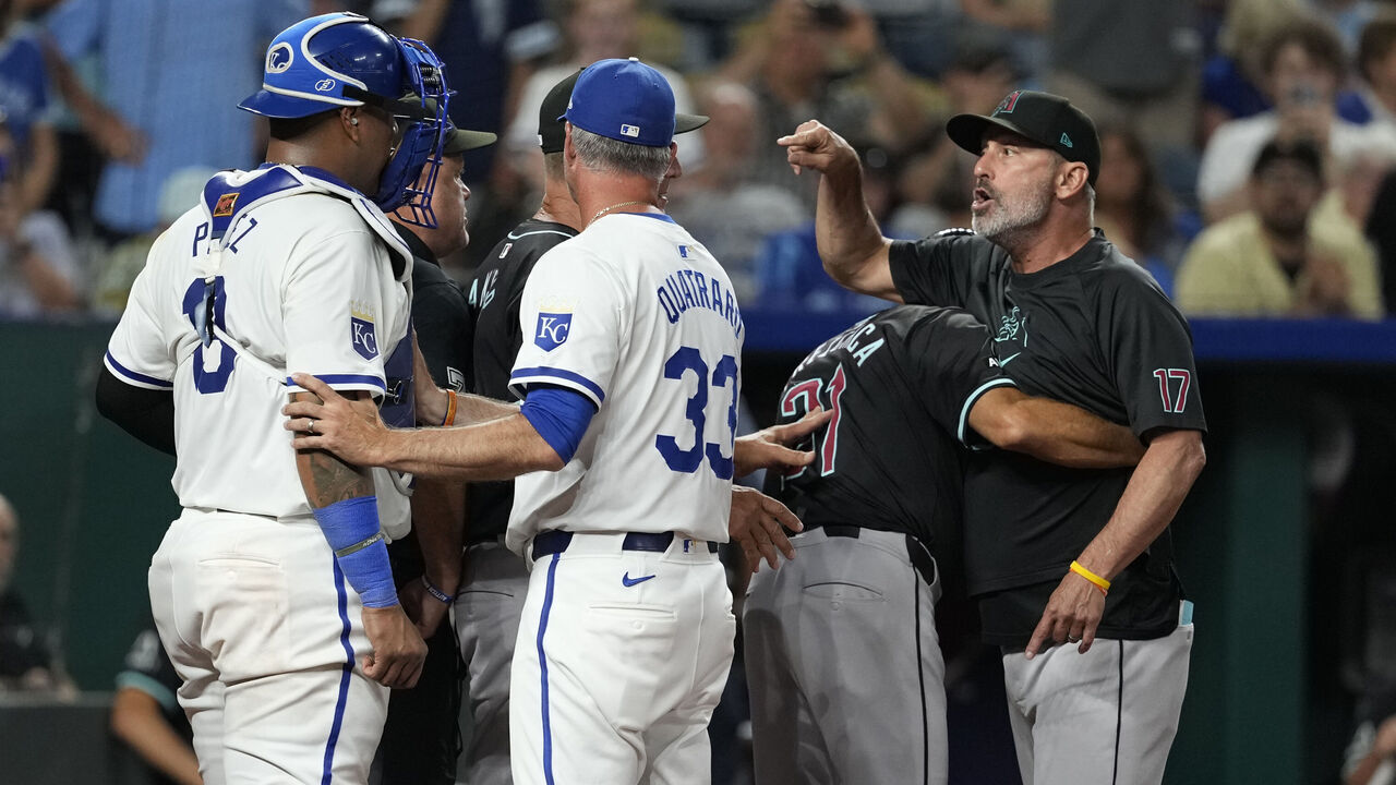 KANSAS CITY, MISSOURI - JULY 22: Manager Torey Lovullo #17 of the Arizona Diamondbacks is held back by Tony Perezchica #21 after being ejected in the seventh inning against the Kansas City Royals at Kauffman Stadium on July 22, 2024 in Kansas City, Missouri.