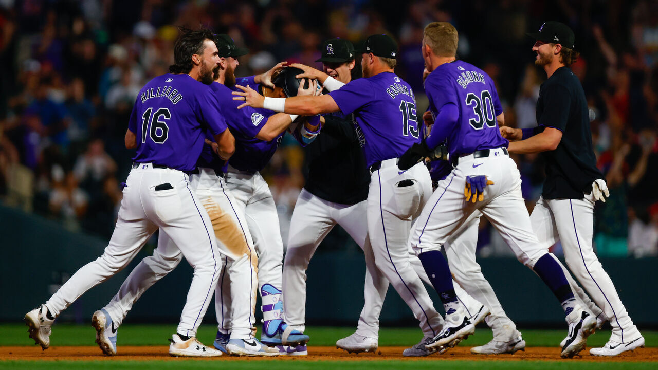DENVER, CO - JULY 22: Ezequiel Tovar #14 of the Colorado Rockies is congratulated by teammates after hitting a game winning RBI single during the 12th inning against the Boston Red Sox at Coors Field on July 22, 2024 in Denver, Colorado. The Rockies won 9-8 in 12 innings.