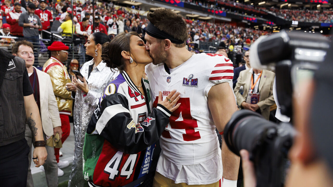 LAS VEGAS, NEVADA - FEBRUARY 11: Kyle Juszczyk #44 of the San Francisco 49ers kisses his wife, Kristin Juszczyk, during pregame warmups before Super Bowl LVIII against the Kansas City Chiefs at Allegiant Stadium on February 11, 2024 in Las Vegas, Nevada.