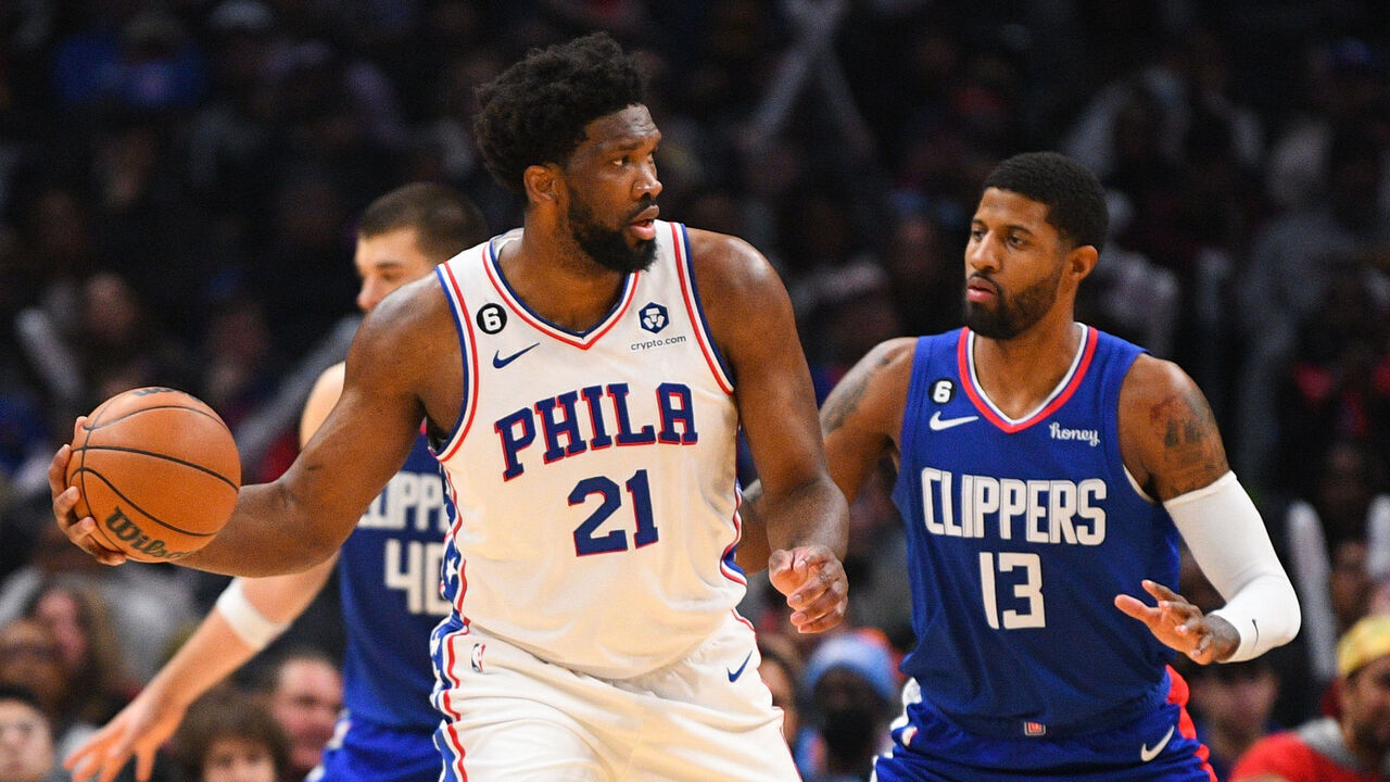 LOS ANGELES, CA - JANUARY 17: Philadelphia 76ers Center Joel Embiid (21) is guarded by Los Angeles Clippers Forward Paul George (13) during a NBA game between the Philadelphia 76ers and the Los Angeles Clippers on January 17, 2023 at Crypto.com Arena in Los Angeles, CA.